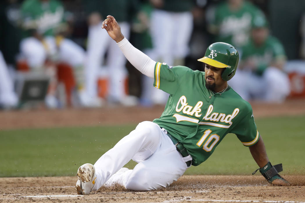 Marcus Semien of the Oakland Athletics scores against the Tampa Bay Rays during the third innin ...