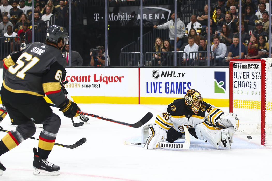 Golden Knights' Mark Stone (61) scores a goal past Boston Bruins goaltender Tuukka Rask (40) du ...