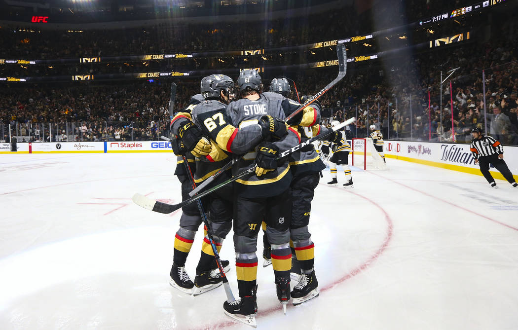 Golden Knights' Mark Stone, center, celebrates his goal with teammates during the first period ...