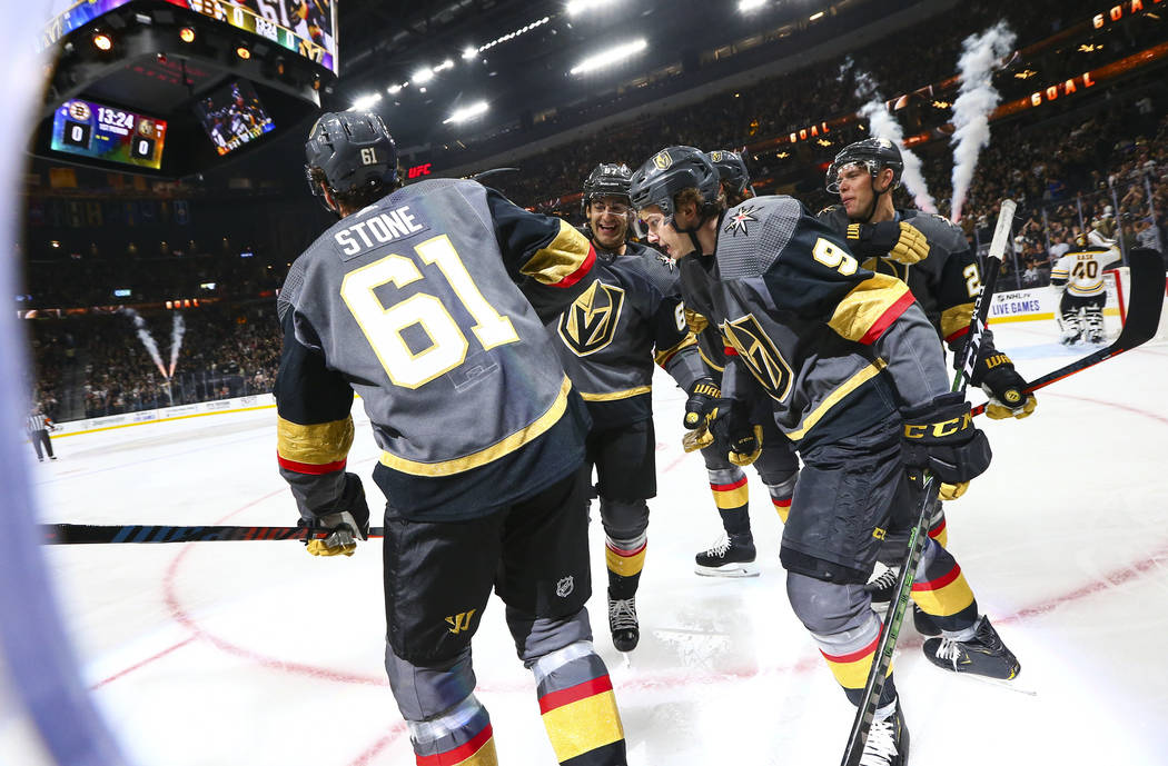 Golden Knights' Mark Stone (61) celebrates his goal with teammates Max Pacioretty, center, and ...