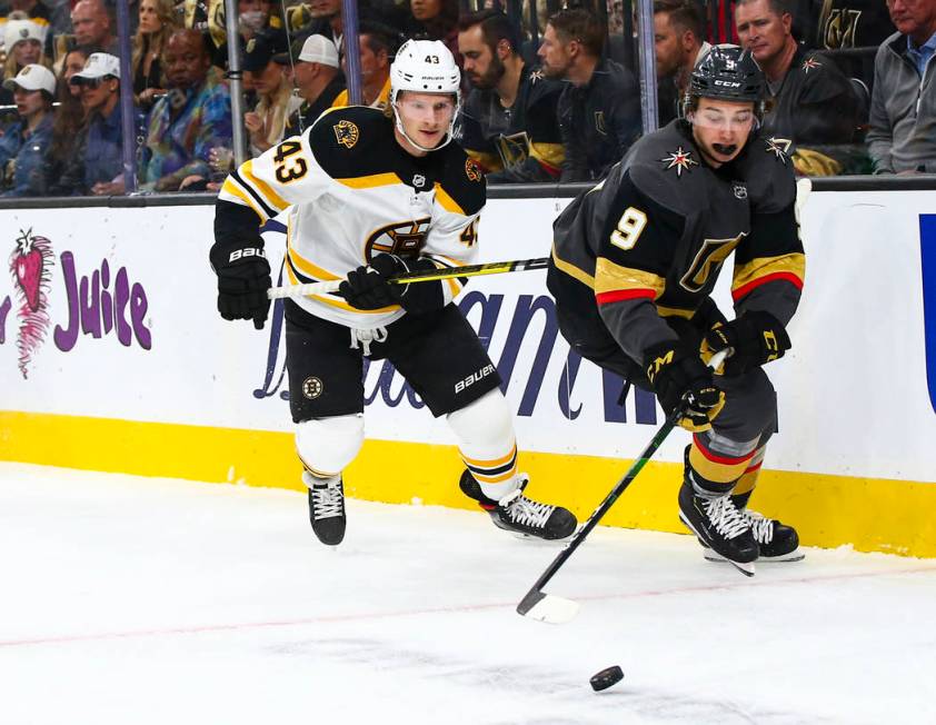 Golden Knights' Cody Glass (9) moves the puck in front of Boston Bruins' Danton Heinen (43) dur ...