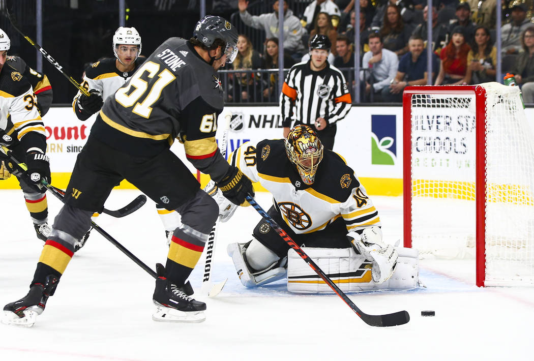 Golden Knights' Mark Stone (61) tries to get the puck past Boston Bruins goaltender Tuukka Rask ...