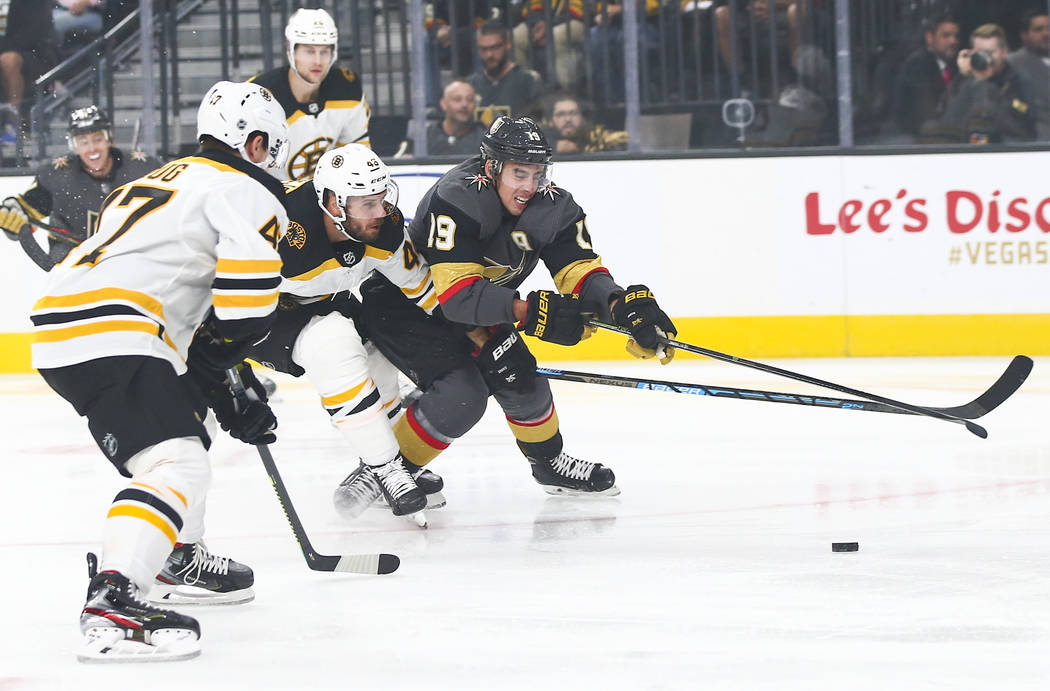 Golden Knights' Reilly Smith (19) battles for the puck against Boston Bruins' David Krejci (46) ...