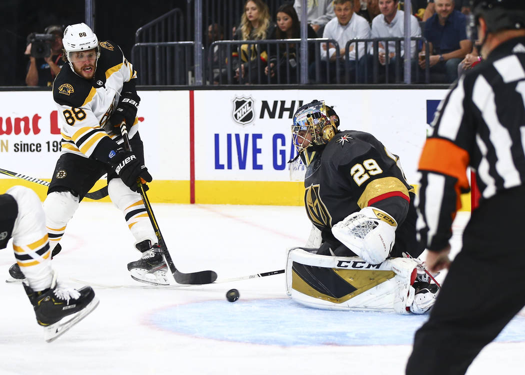 Golden Knights goaltender Marc-Andre Fleury (29) blocks a shot from Boston Bruins' David Pastrn ...
