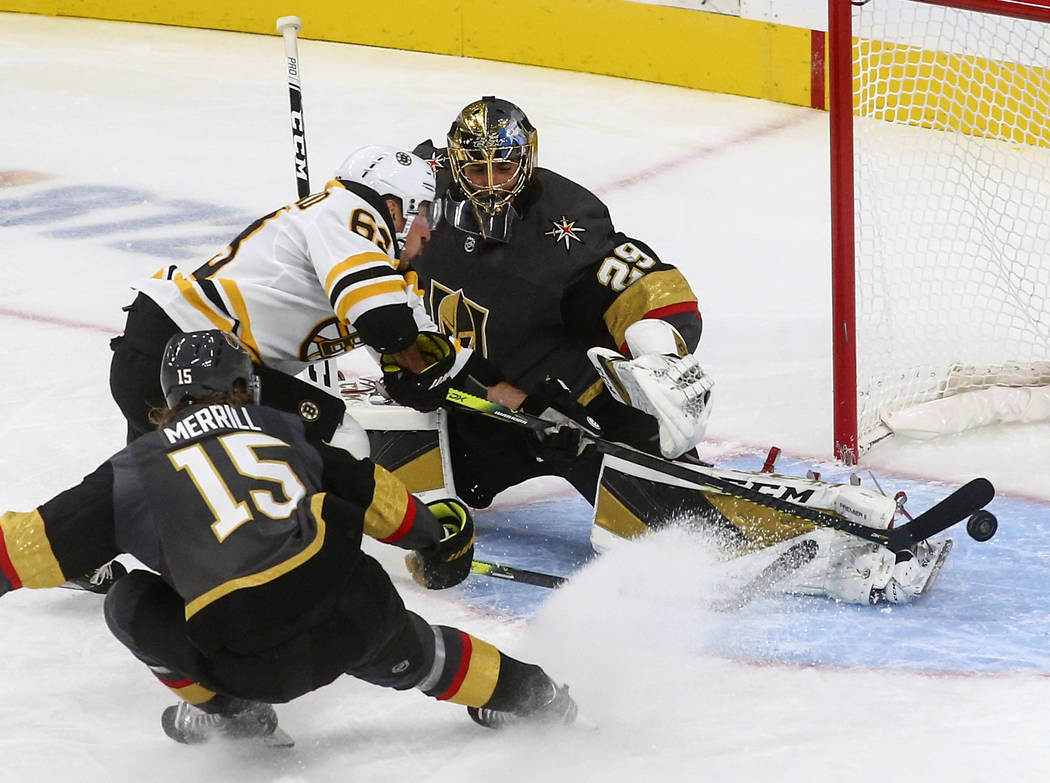 Golden Knights goaltender Marc-Andre Fleury (29) blocks a shot from Boston Bruins' Brad Marchan ...
