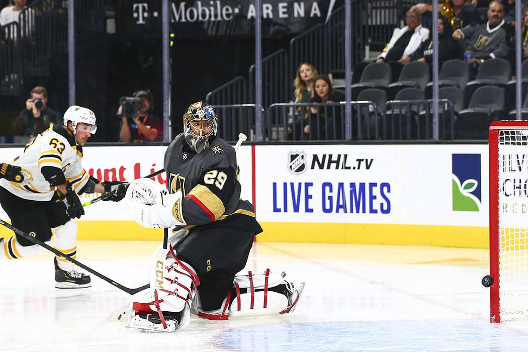 Boston Bruins' Brad Marchand (63) scores a goal past Golden Knights goaltender Marc-Andre Fleur ...