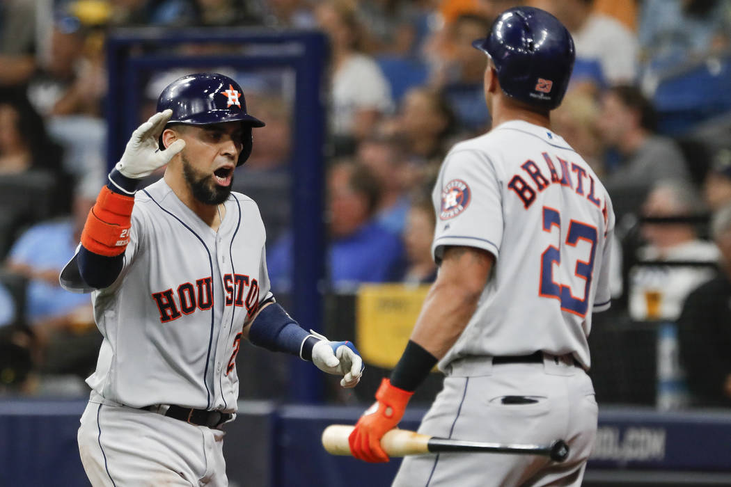 Houston Astros' Robinson Chirinos, left, celebrates his home run against the Tampa Bay Rays wit ...