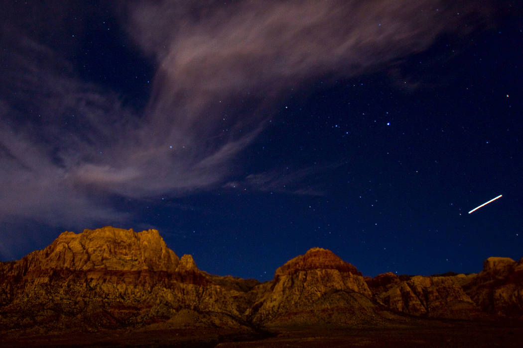 A meteor streaks across the sky in this time-lapse photograph at Red Rock Canyon National Conse ...