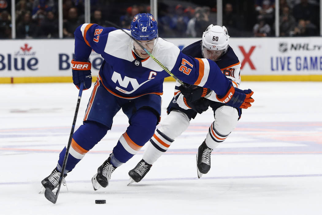 New York Islanders center Anders Lee (27) skates past Edmonton Oilers center Markus Granlund (6 ...