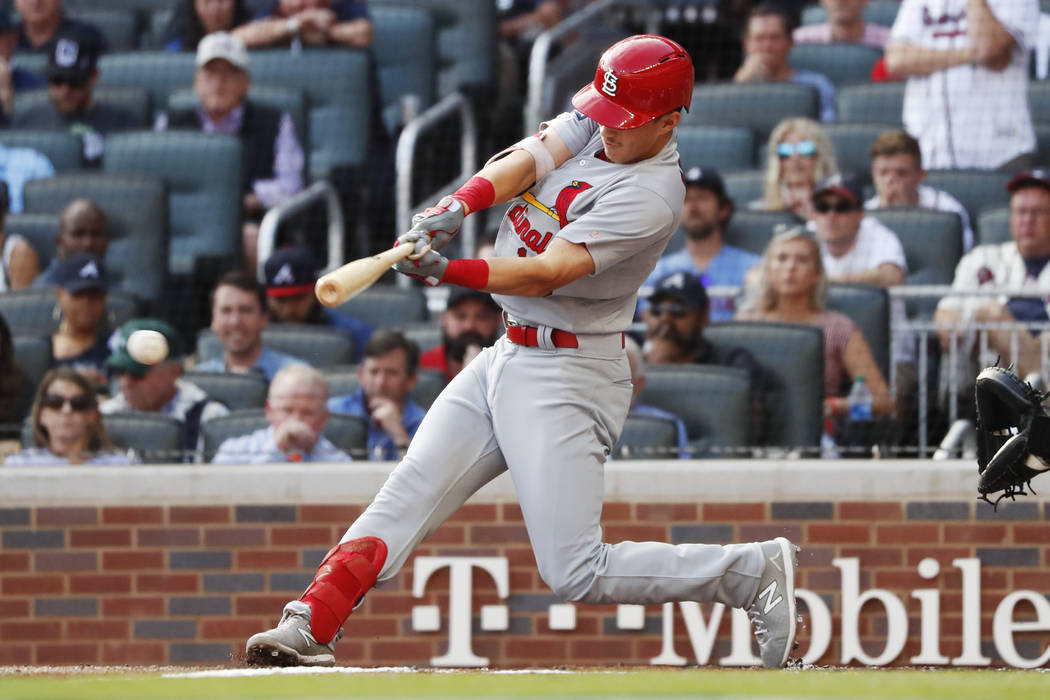 St. Louis Cardinals' Tommy Edman doubles to score teammates Marcell Ozuna and Yadier Molina dur ...