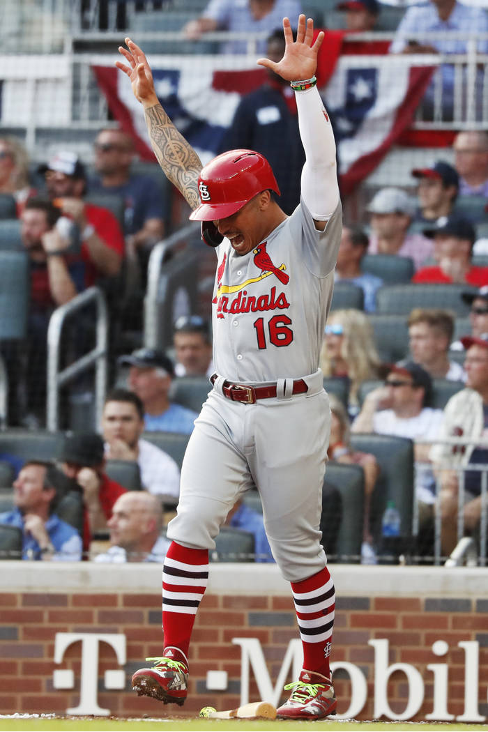 St. Louis Cardinals' Kolten Wong celebrates after scoring on a wild pitch by Atlanta Braves pit ...