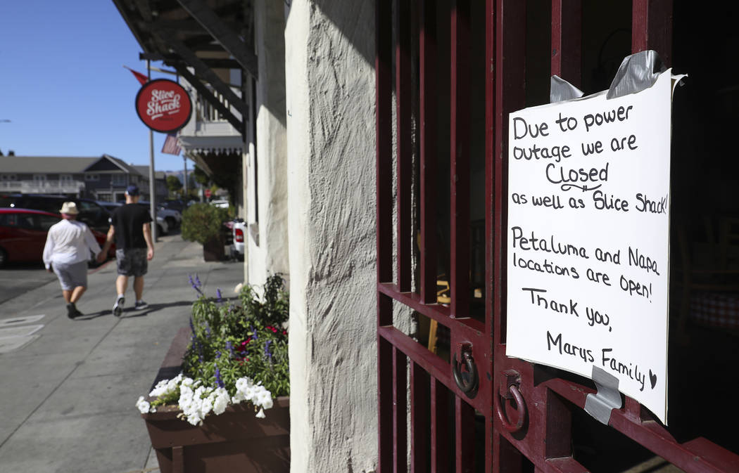 A sign at Mary's Pizza Shack informs customers of their closure due to a PG&E power shutdow ...