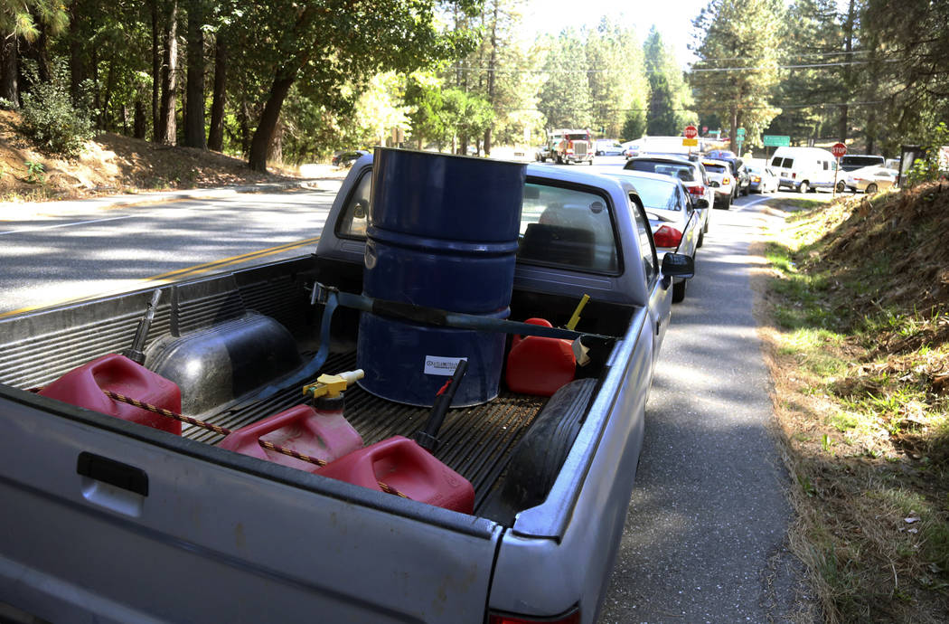 People wait in line for gas at Robinson Enterprises in Nevada City, Calif., Wednesday, Oct. 9, ...