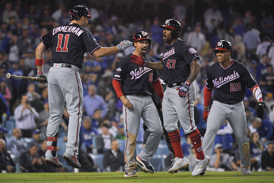 Washington Nationals' Howie Kendrick (47) celebrates after a grand slam against the Los Angeles ...