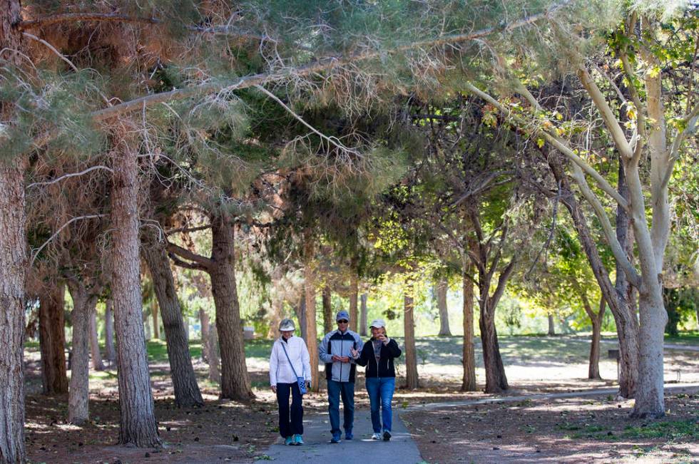 Jody Tomaszewski, from left, walks with her husband Ted Tomaszewski, and their friend Louis Etz ...