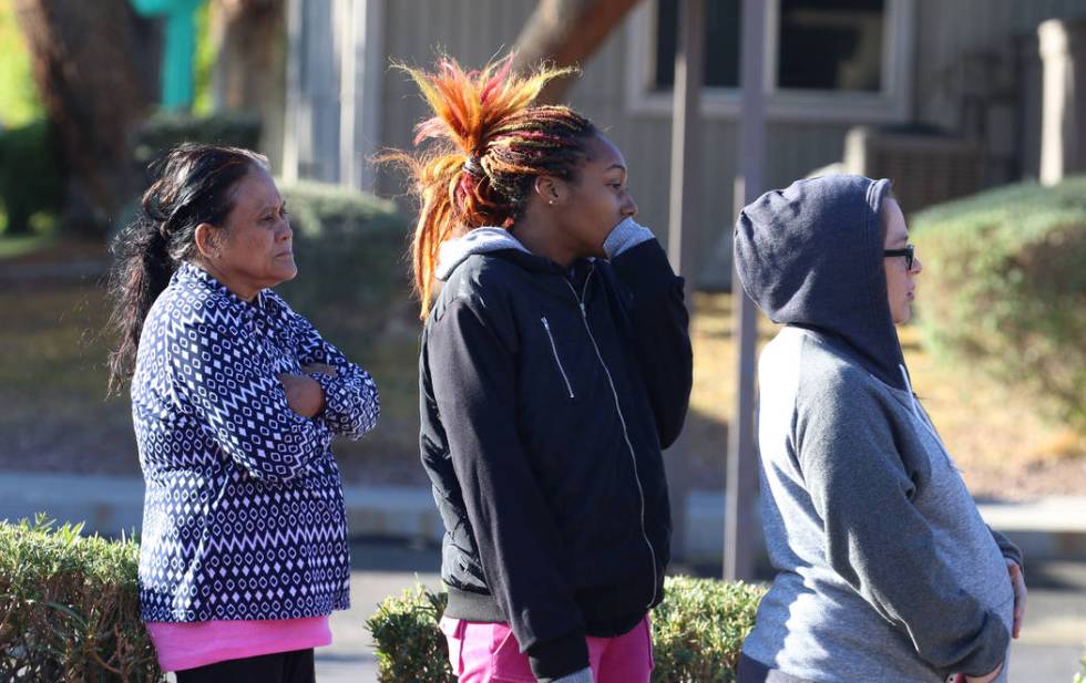 Parents bundled up as they watch their children board the school bus at West Viking Road in La ...