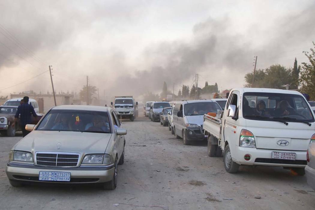 Syrians flee shelling by Turkish forces in Ras al Ayn, northeast Syria, Wednesday, Oct. 9, 2019 ...