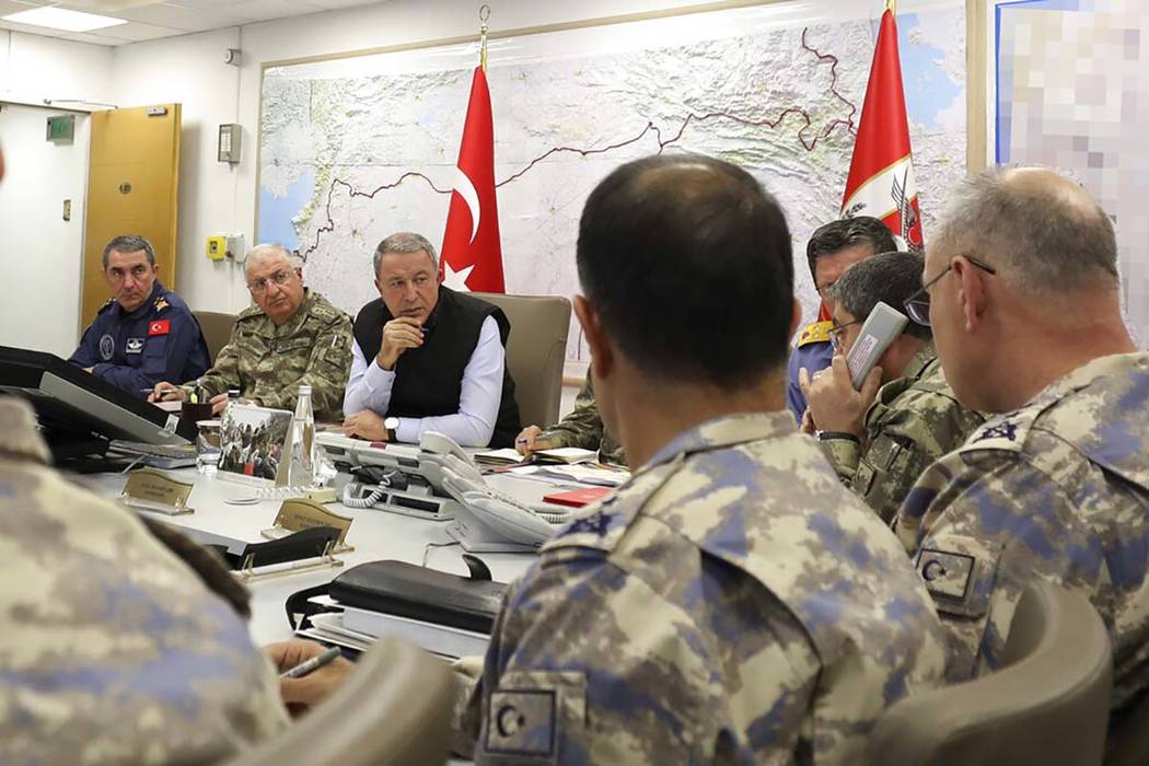 In this photo taken late Wednesday, Oct. 9, 2019, Turkey's Defence Minister Hulusi Akar, center ...