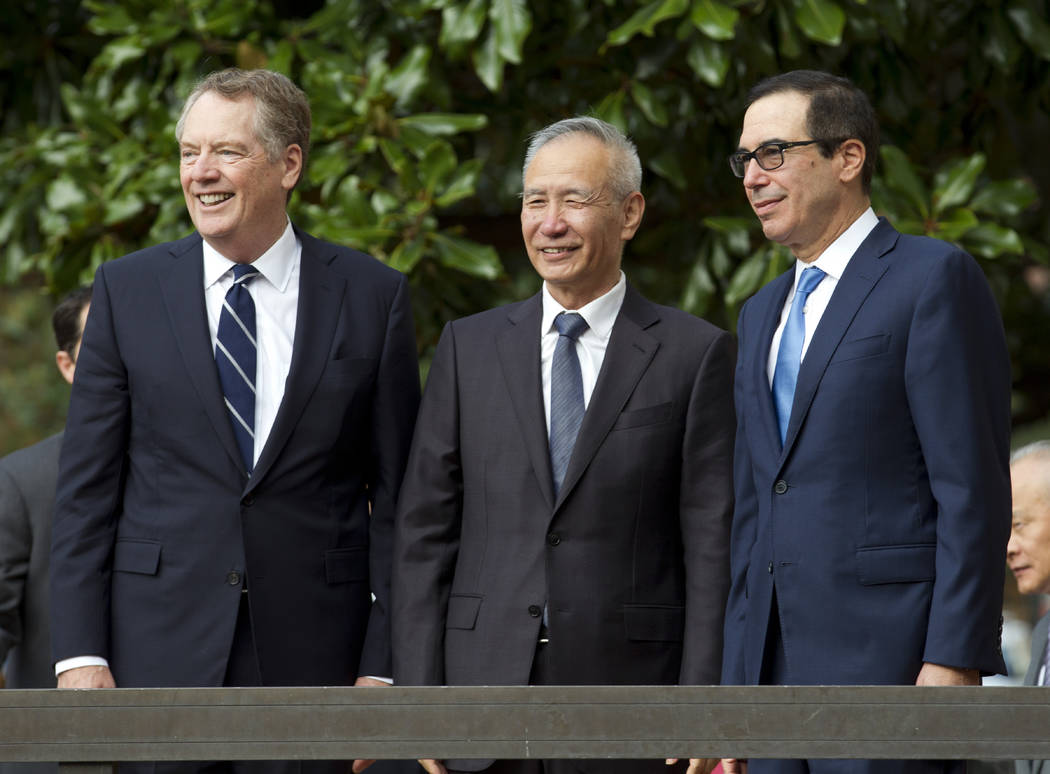 Chinese Vice Premier Liu He accompanied by U.S. Trade Representative Robert Lighthizer, left, a ...