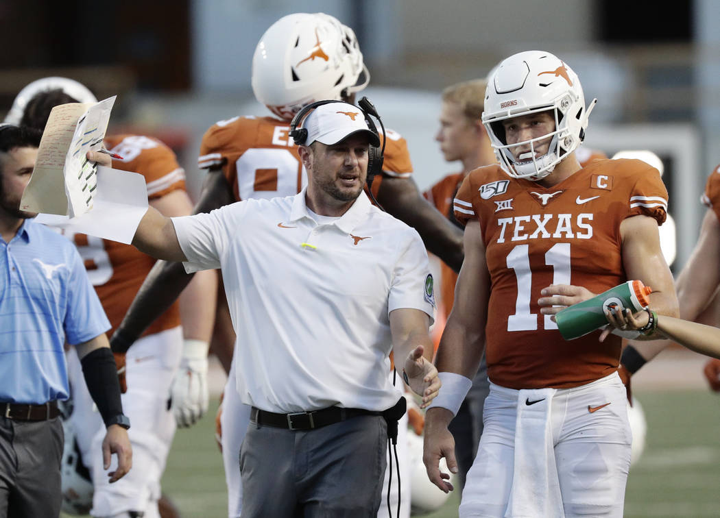 Texas head coach Tom Herman, left, and Texas quarterback Sam Ehlinger (11) during the first hal ...
