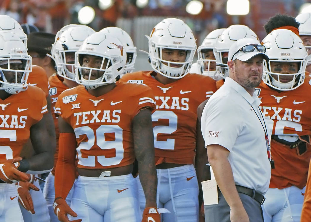 Texas head coach Tom Herman waits with his team before the start of an NCAA college football ga ...