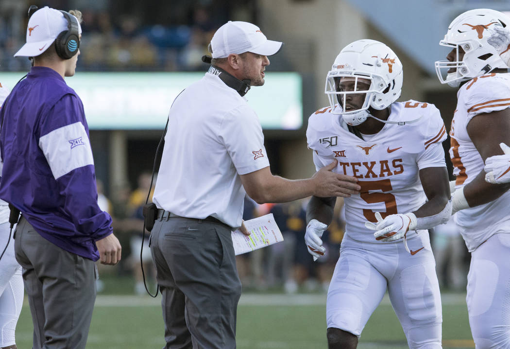 Texas head coach Tom Herman talks to defensive back D'Shawn Jamison (5) during the second half ...
