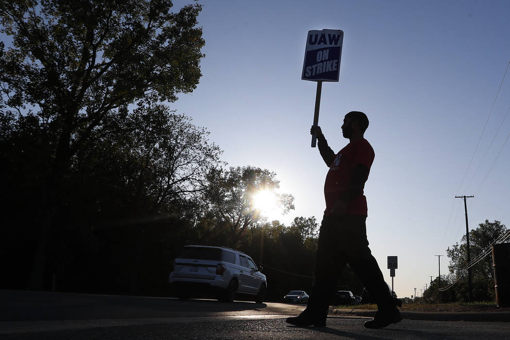 A member of the United Auto Workers walks the picket line at the General Motors Romulus Powertr ...