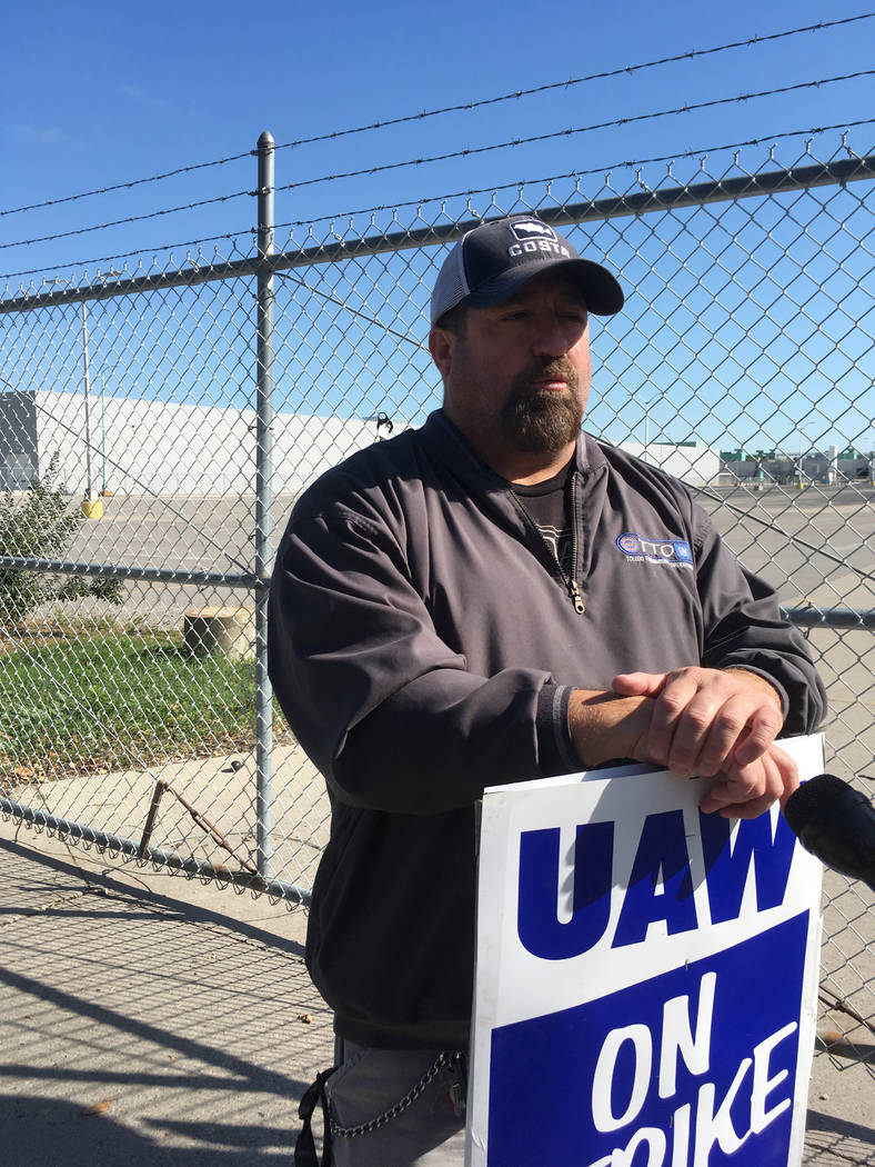 In this Tuesday, Oct. 8, 2019, photo, striking General Motors worker Mike Armentrout stands on ...