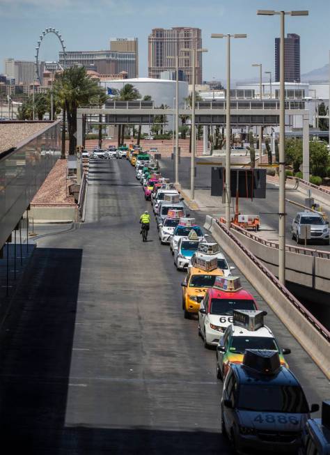 Taxis wait outside Terminal 1 at McCarran International Airport on Thursday, June 28, 2018, in ...