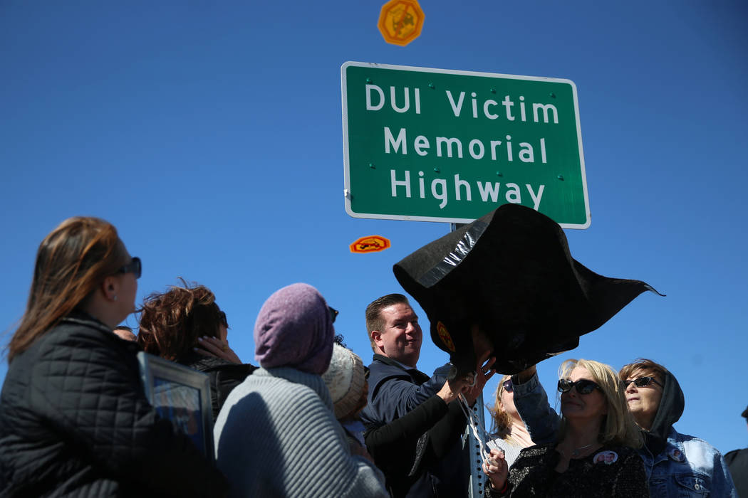 The DUI Victim Memorial Highway sign is unveiled during an event on Kyle Canyon Road near U.S. ...