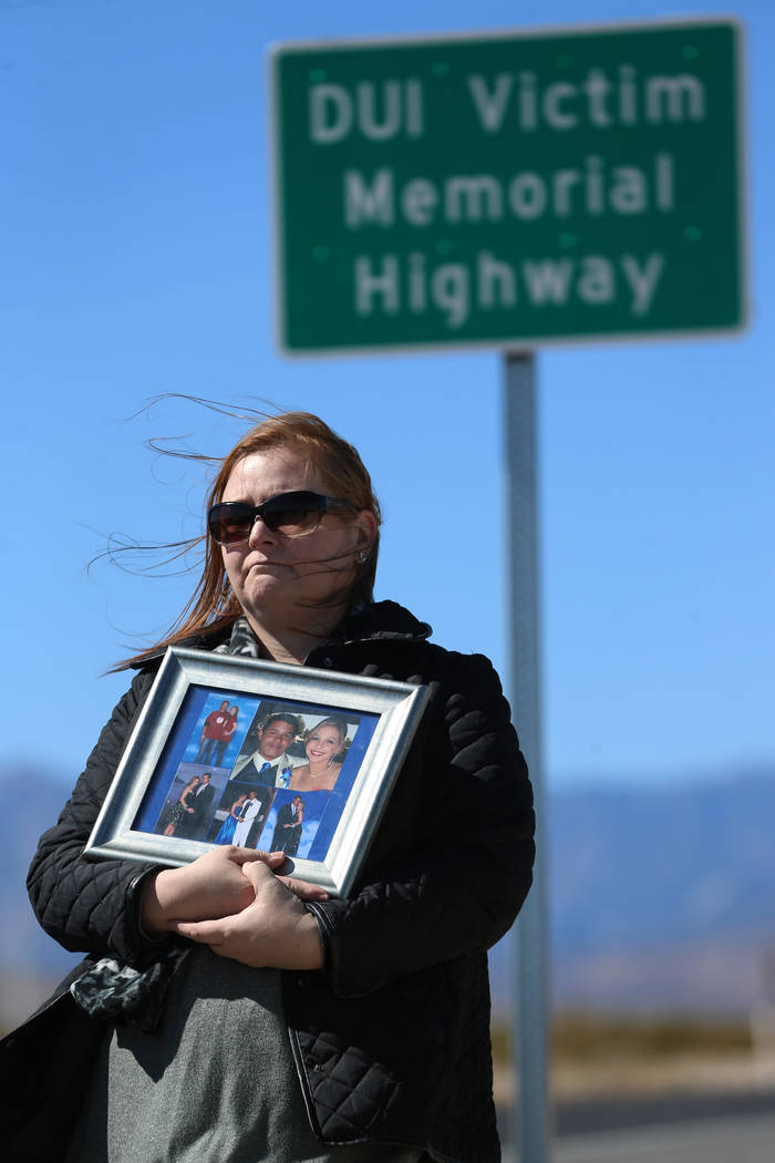 Crystal Hill is seen holding a picture of her son Jesse, who was killed by an impaired driver o ...