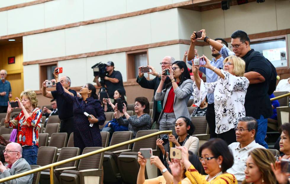 Attendees take photos before the start of the inaugural meeting of the 15-member Asian-American ...