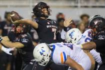 UNLV Rebels quarterback Kenyon Oblad (7) just gets a pass off before the rush from Boise State ...