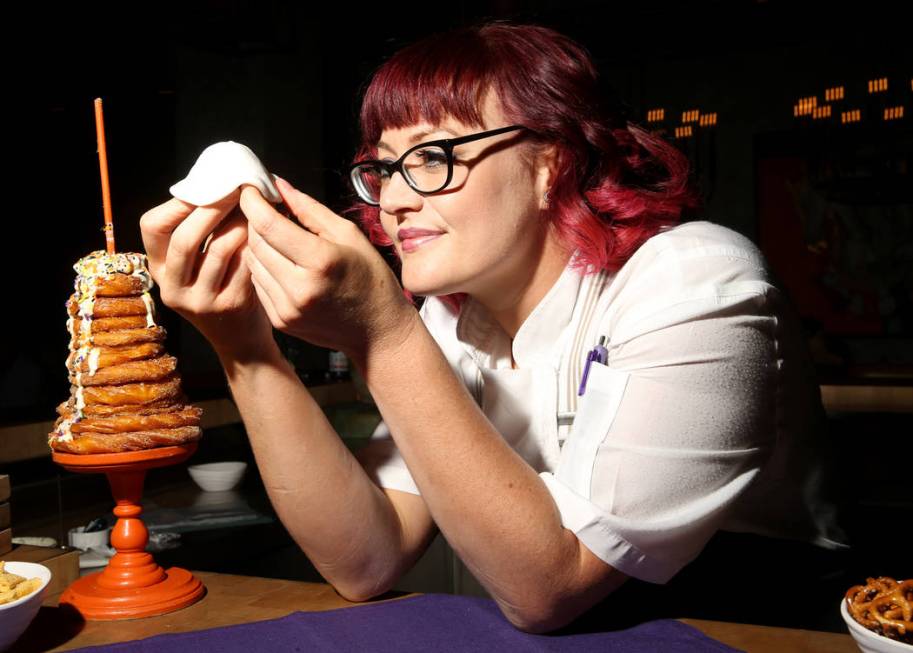 Pastry chef Sara Steele makes a Halloween ghost using fondant over a donut hole at Chica at The ...