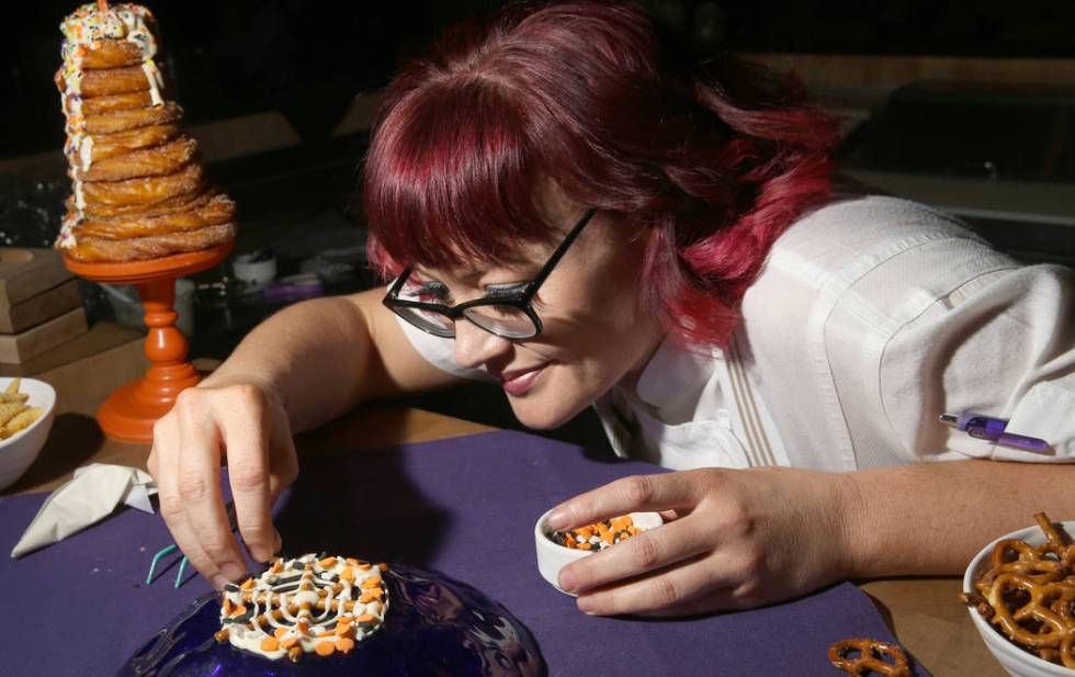 Pastry chef Sara Steele makes a Halloween spider web using pretzel sticks at Chica at The Venet ...