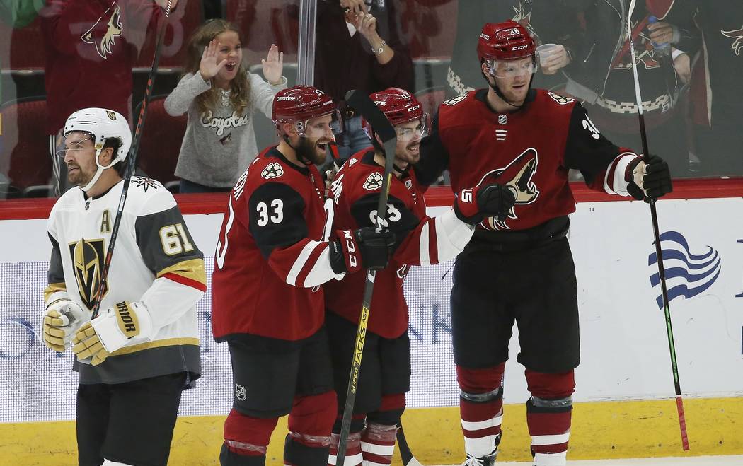 Arizona Coyotes right wing Conor Garland, second from right, celebrates his goal with Coyotes d ...