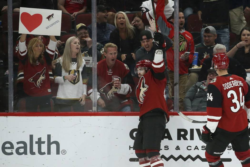 Arizona Coyotes right wing Conor Garland, left, celebrates his goal against the Vegas Golden Kn ...