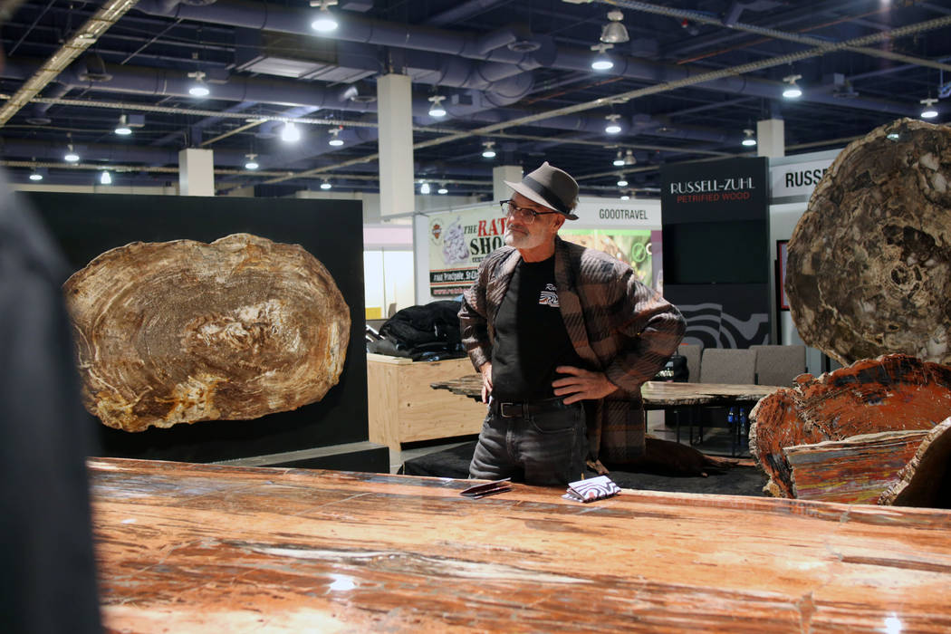 Ralph Thompson of Massachusetts, owner of Russell-Zuhl Petrified Wood, stands in front of a pe ...
