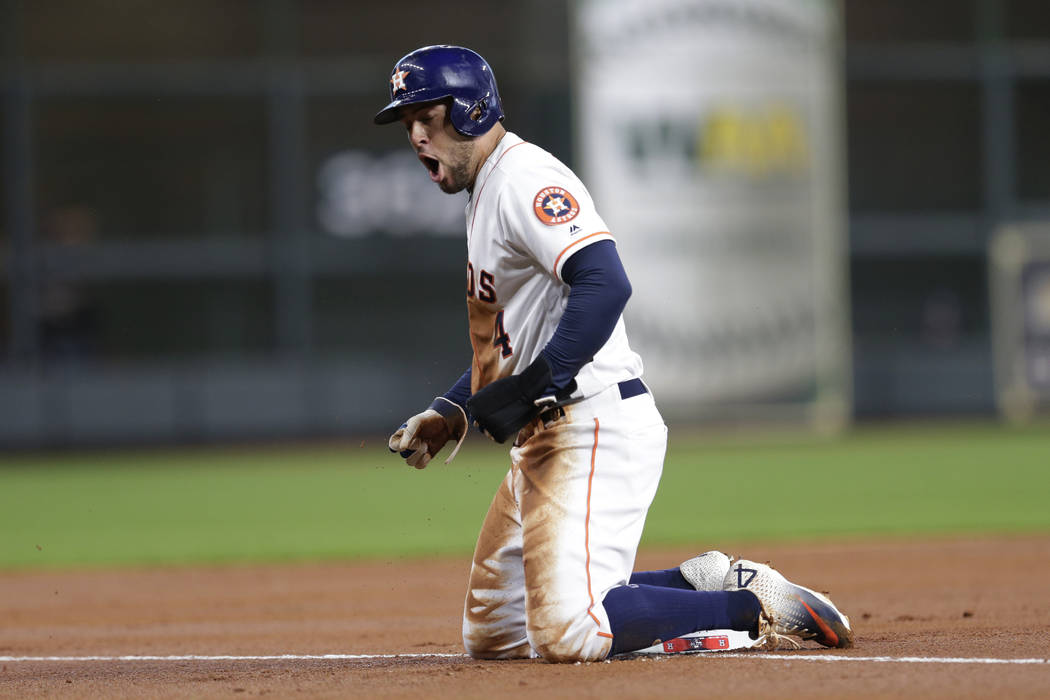 Houston Astros center fielder George Springer reacts after advancing to third base against the ...