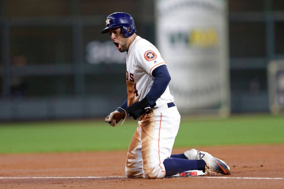 Houston Astros center fielder George Springer reacts after advancing to third base against the ...