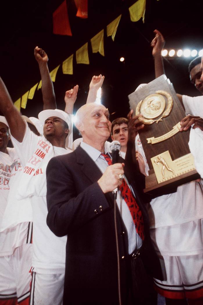 UNLV head basketball coach Jerry Tarkanian stands with his team after the Runnin' Rebels won th ...