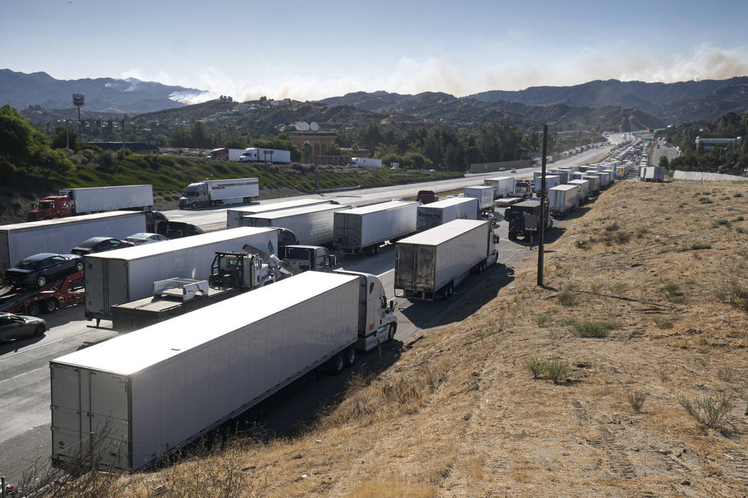 Miles of trucks wait along the I-5 freeway in Newhall, Calif., as the major roadway leading int ...