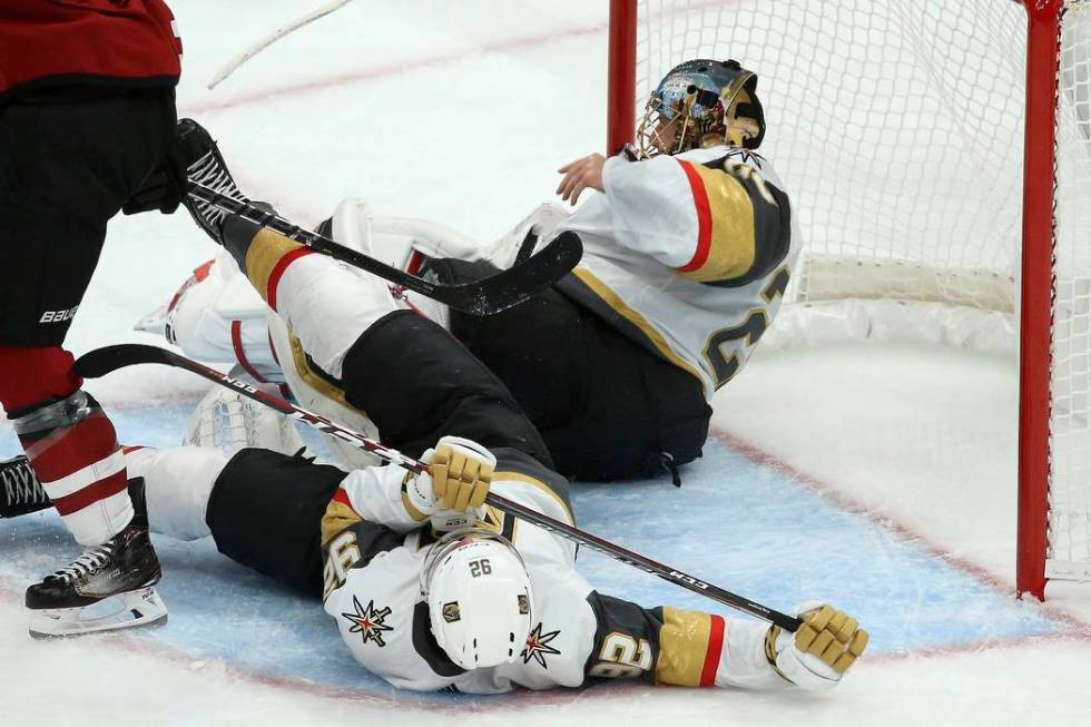 Vegas Golden Knights left wing Tomas Nosek (92) collides with Golden Knights goaltender Marc-An ...