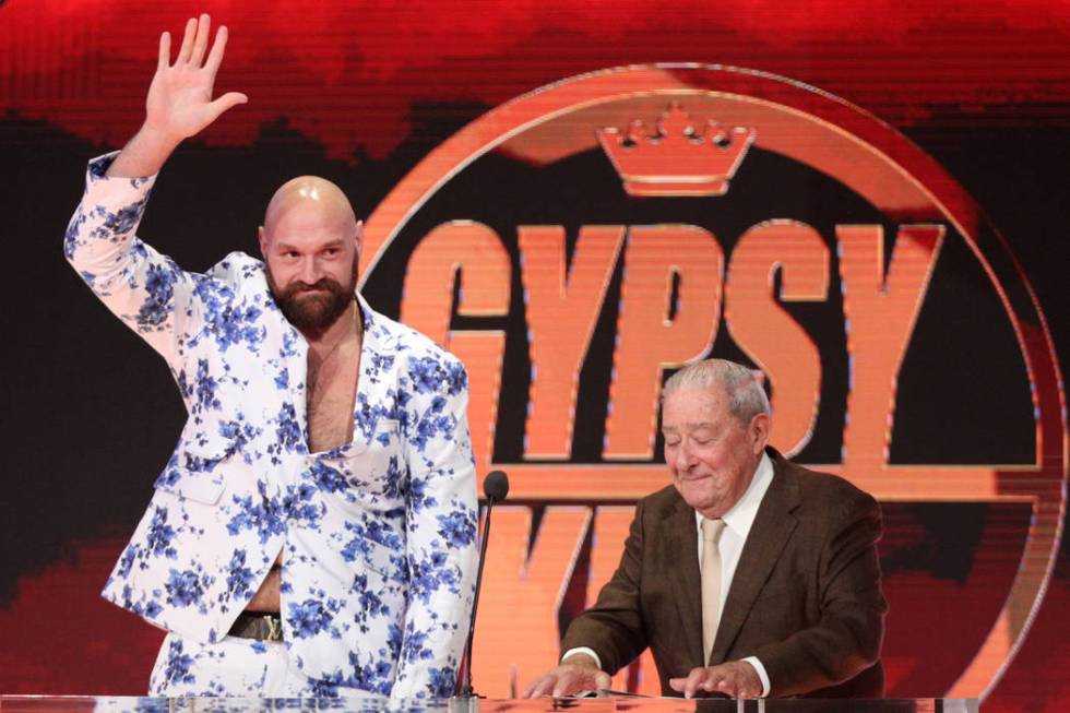 Boxer Tyson Fury, left, with Top Rank boxing CEO Bob Arum, during a World Wrestling Entertainme ...