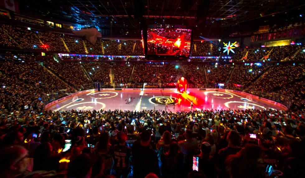 Lighted bracelets twinkle on the wrists of Vegas Golden Knights fans before the start of the fi ...