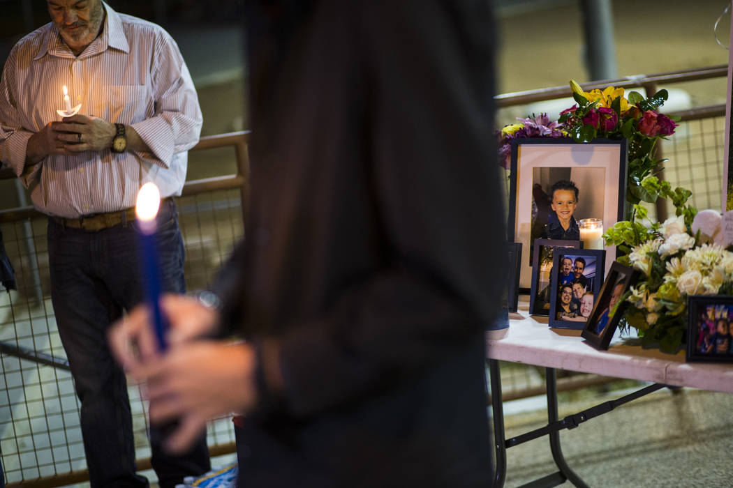 Chuck Wheeler, left, mourns his grandson, Gavin Murray Palmer, who was lost in a house fire, du ...