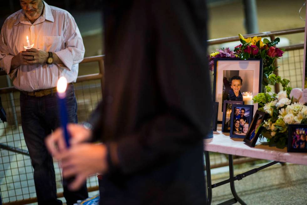 Chuck Wheeler, left, mourns his grandson, Gavin Murray Palmer, who was lost in a house fire, du ...