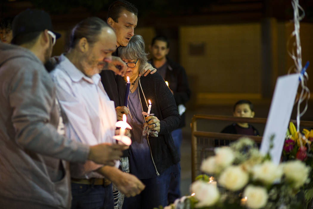 Chuck Wheeler, second from left, mourns his grandson, Gavin Murray Palmer, alongside Sean Murra ...