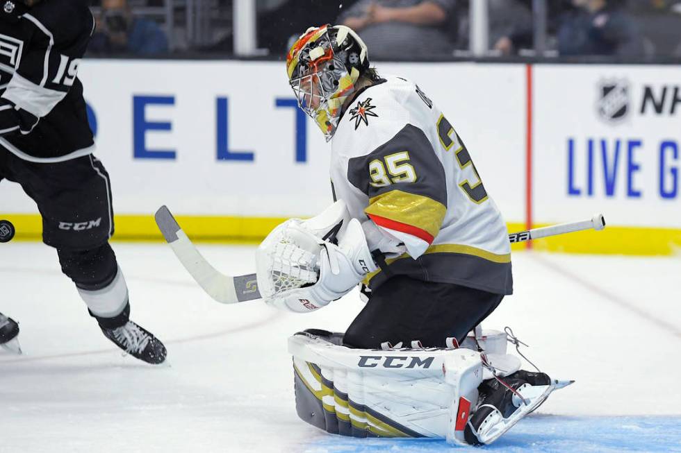 Vegas Golden Knights goaltender Oscar Dansk, right deflects a shot as Los Angeles Kings left wi ...