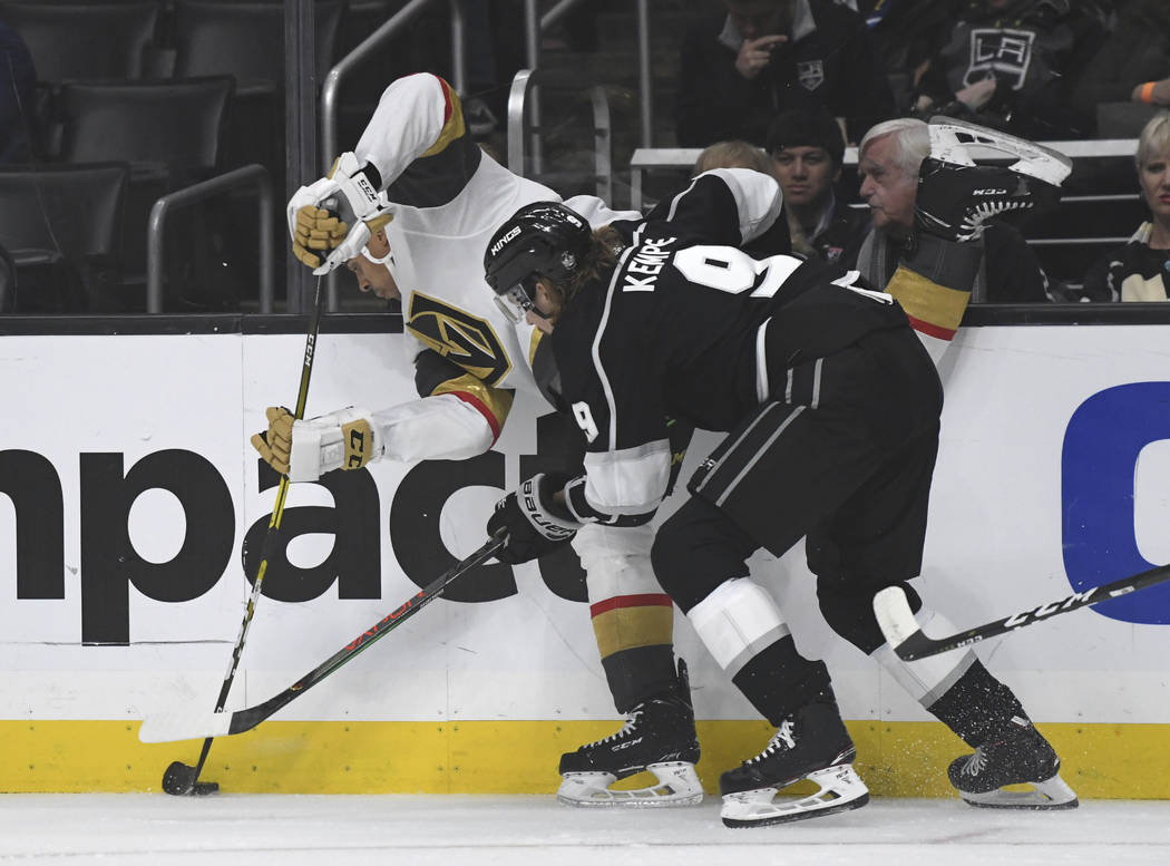 Los Angeles Kings right wing Adrian Kempe, of Sweden, right, checks Vegas Golden Knights right ...